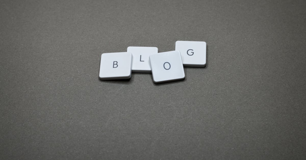 White Scrabble tiles spelling 'Blog' against a minimalist gray background.